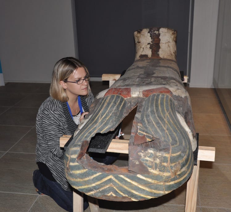 Caroline Arbuckle MacLeod examines an Egyptian coffin. 