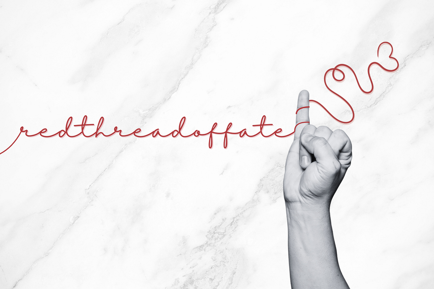 A black and white photograph shows a human hand positioned on the right side of the frame, with the index finger pointing upward. A thin red thread or string is tied around the finger and extends across the image, forming cursive lettering that spells out "redthreadoffate" in elegant script. The background appears to be white marble or a similar textured surface with subtle gray veining. The contrast between the monochromatic hand and background against the vibrant red thread creates a striking visual representation of the mystical concept of destiny and connection.