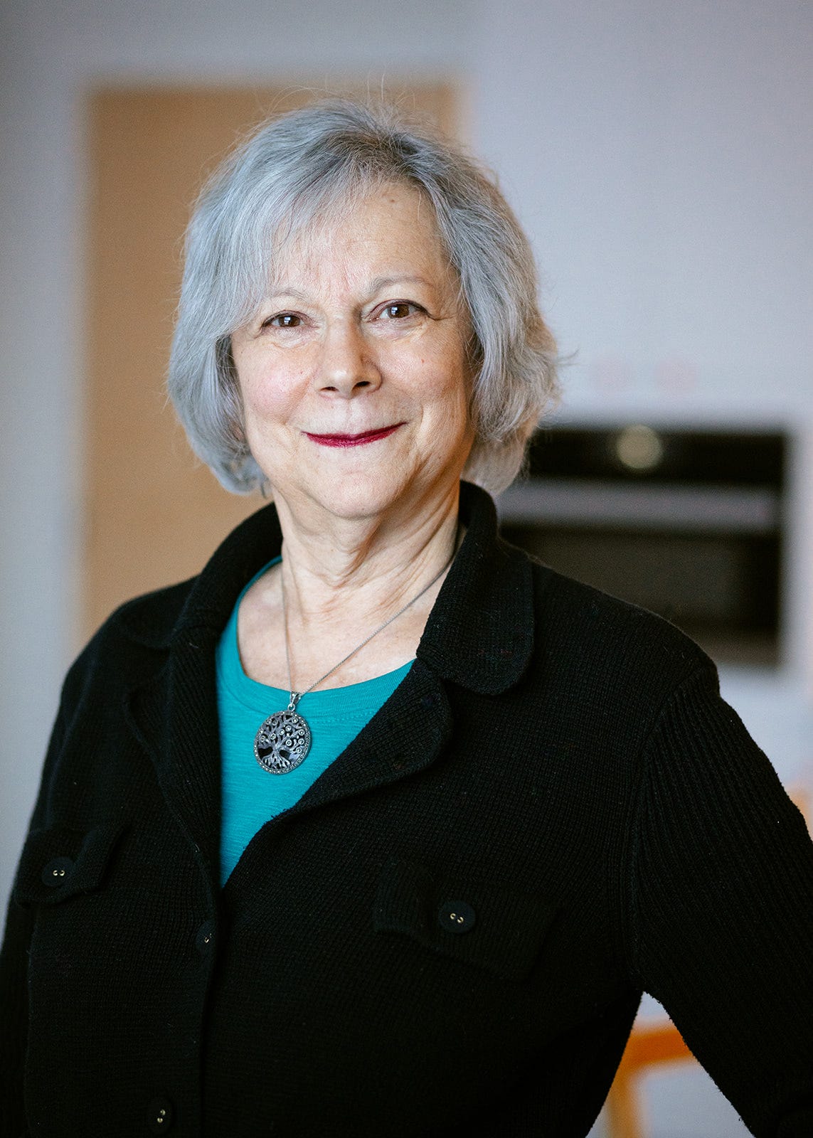 Image of Kayla Epstein with red lipstick and a black sweater