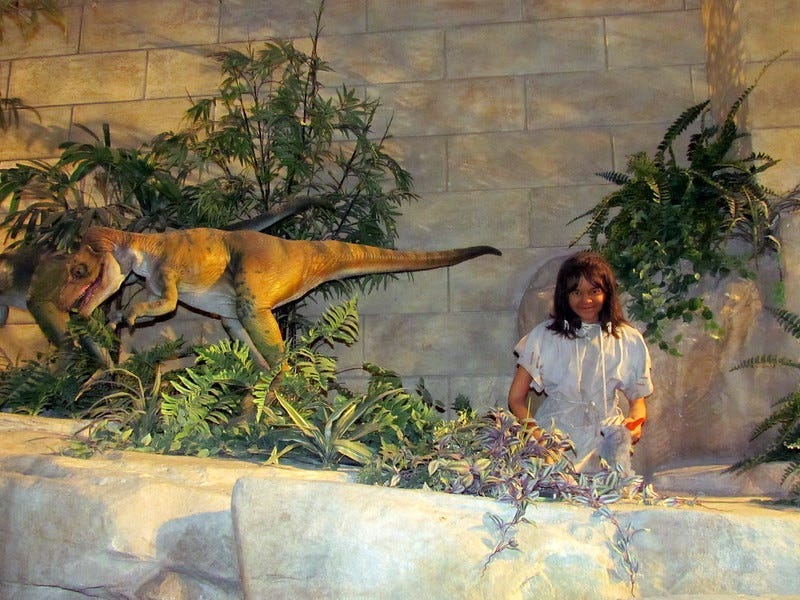 A depiction of dinosaurs living alongside humans, peacefully A depiction of dinosaurs living alongside humans, peacefully
