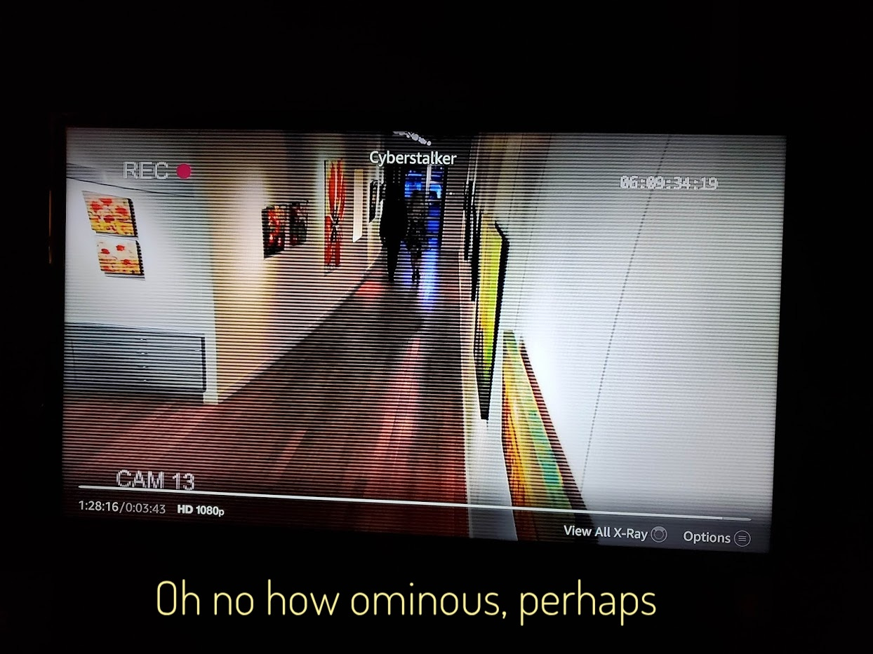 Security camera footage of Aiden and Paul leaving the gallery, captioned "Oh no how ominous, perhaps"