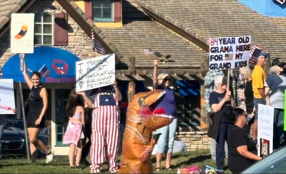 A group of people holding signs

AI-generated content may be incorrect.