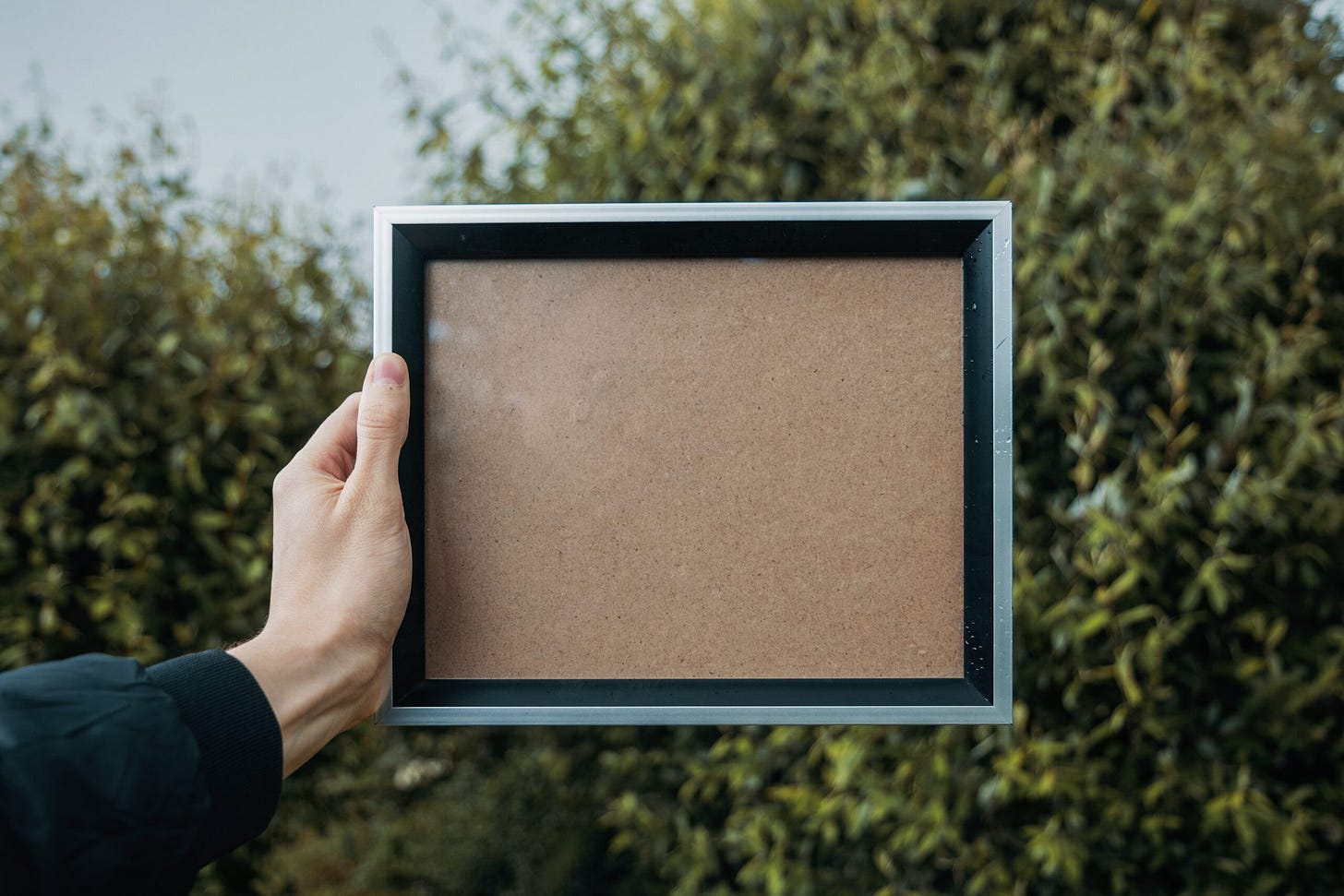 Person holding an empty frame Person holding an empty frame
