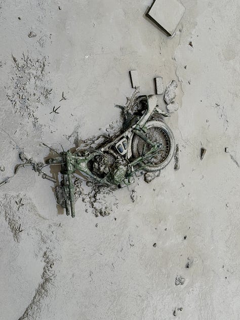 Machinery and industrial detritus emerging from sludge