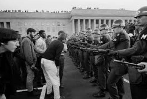 A group of people standing in a line with police officers

AI-generated content may be incorrect.