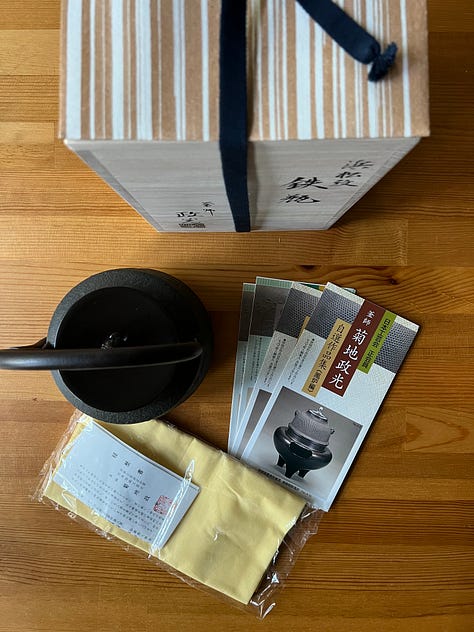 A Japanese tetsubin with packaging and on a hot plate