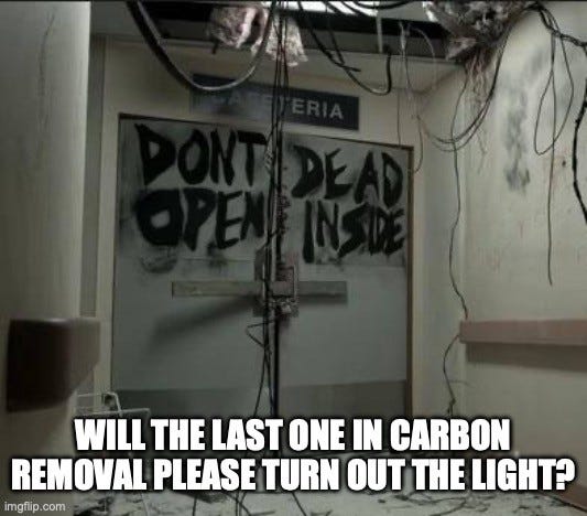 Still from The Walking Dead: chained cafeteria doors spray-painted "DONT OPEN DEAD INSIDE" under dangling ceiling wires. Caption: "WILL THE LAST ONE IN CARBON REMOVAL PLEASE TURN OUT THE LIGHT?"