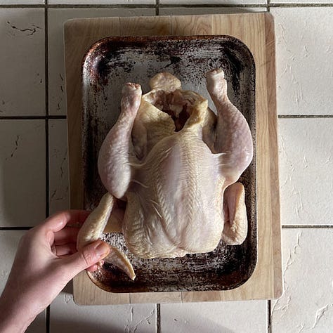 Tucking the chicken wing under for roasting