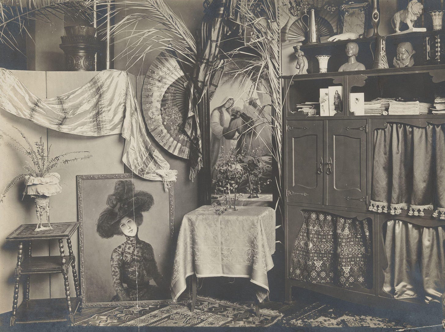 Interior with a cabinet, sculptures and a painting.