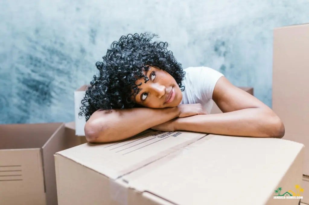 a woman resting her head on a cardboard box