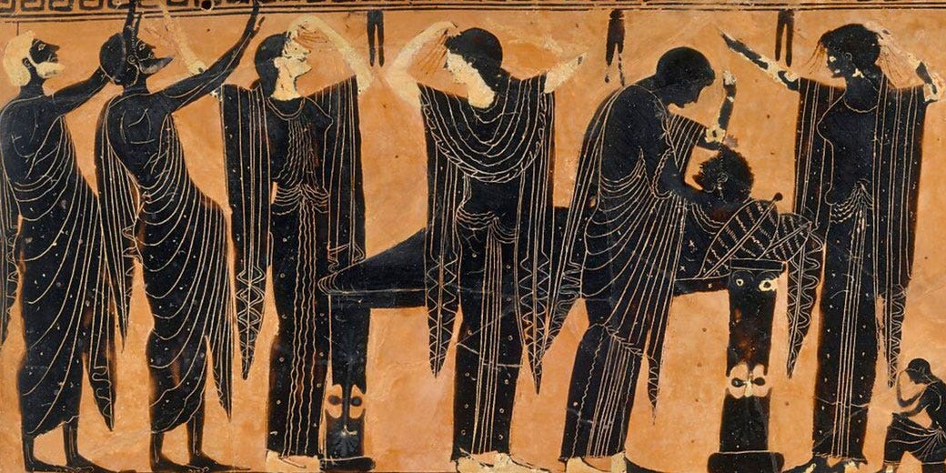 Ancient Greek vase art showing mourners surrounding a laid-out body, with stylized gestures and detailed drapery on a terracotta background.