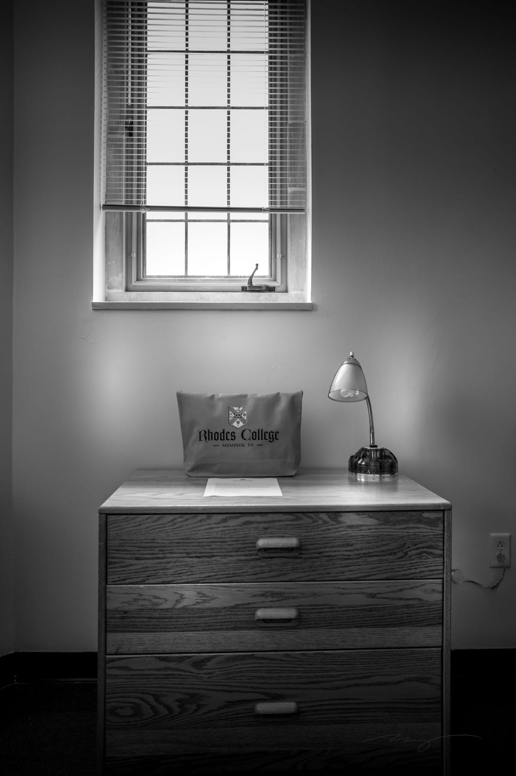 dorm room window and desk with study lamp and bag dorm room window and desk with study lamp and bag