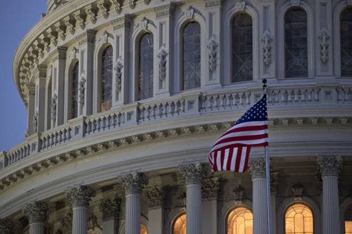 the american flag flies outside the u.s. capitol before sunrise - washington dc congress building stock pictures, royalty-free photos & images