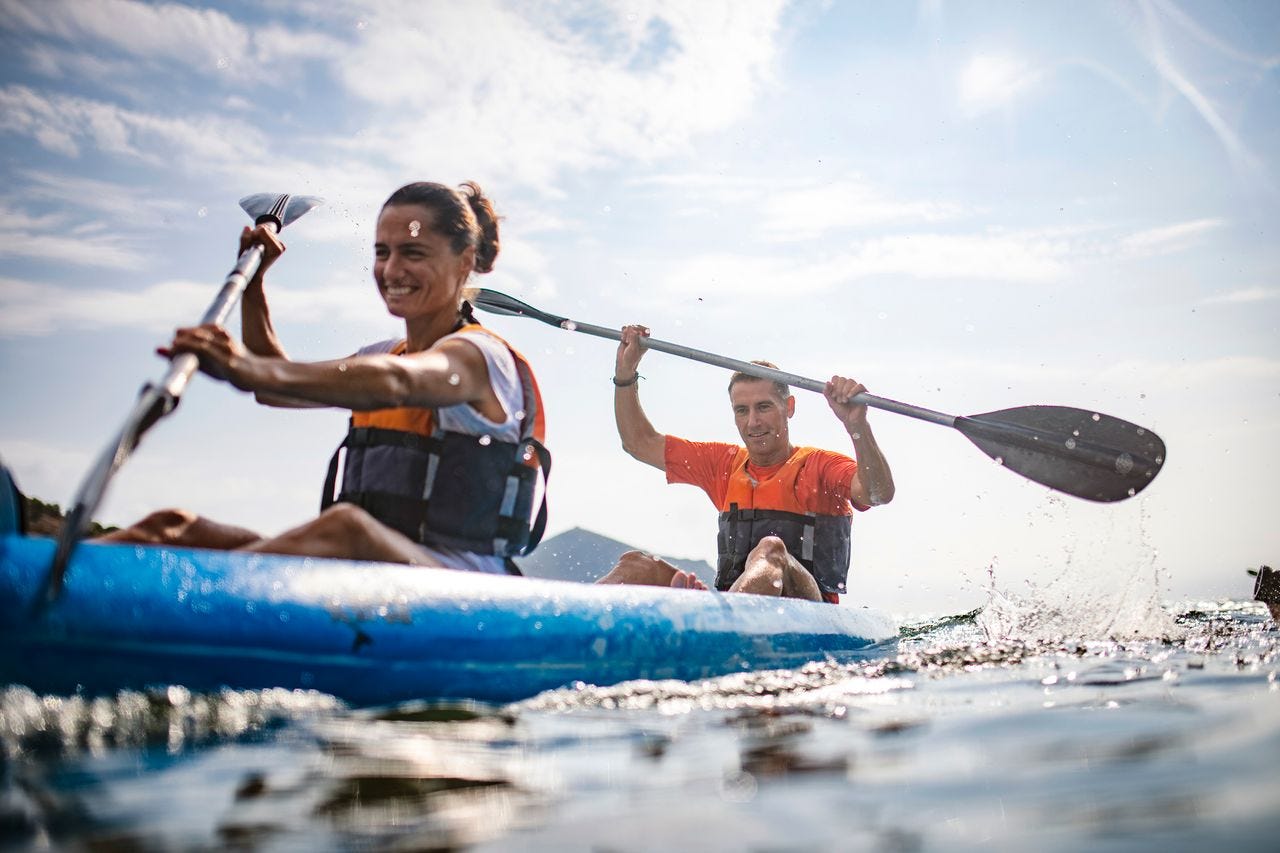 Man and woman paddling in a kayak Man and woman paddling in a kayak