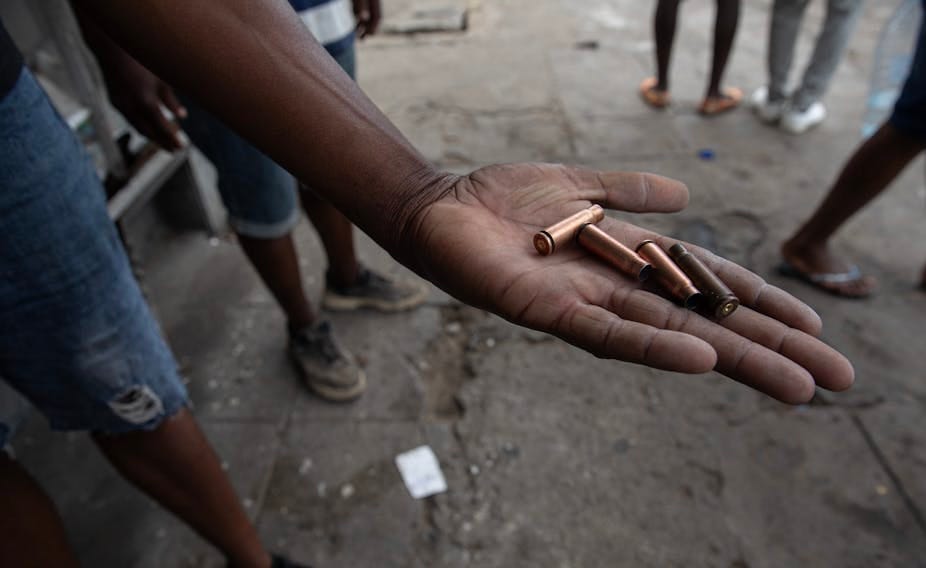 A protester shows bullet casings allegedly fired by police during a protest in Maputo on