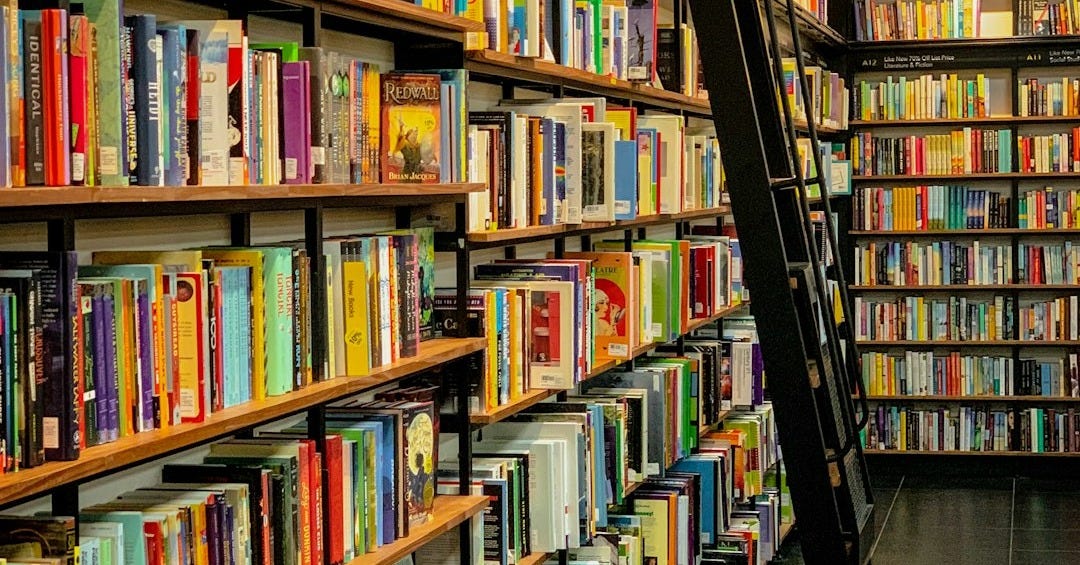 a long row of books on shelves in a library a long row of books on shelves in a library