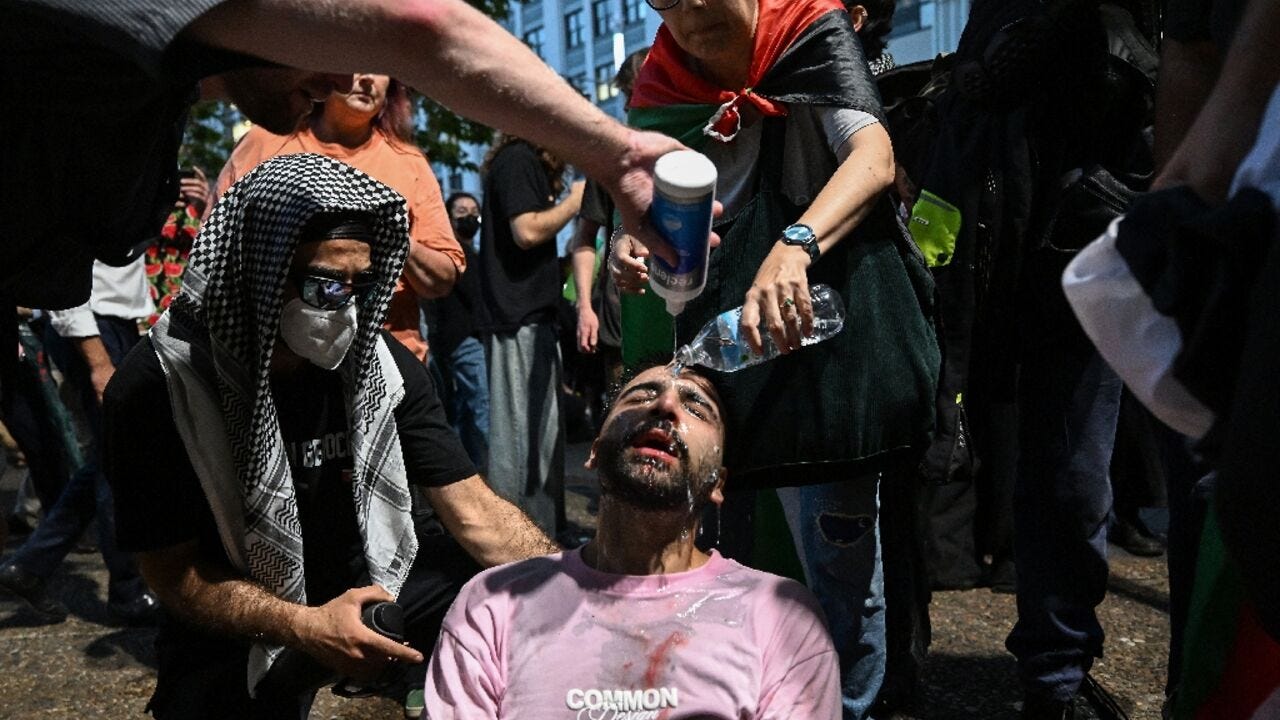 A protester is helped after police deployed pepper spray to disperse demonstrators taking part in a Pro-Palestinian rally against Israeli President Isaac Herzog's visit to Australia in Sydney on February 9, 2026