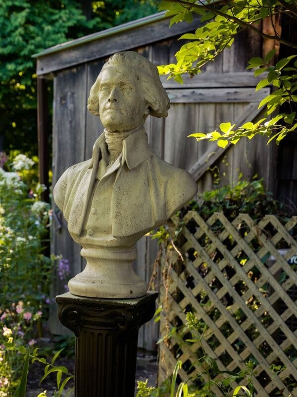 A greenish bust of Thomas Jefferson in Kincaid’s garden.