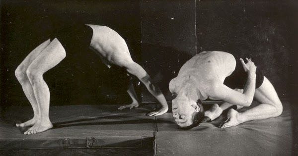This may contain: two men are performing acrobatic tricks on a bed in an old black and white photo This may contain: two men are performing acrobatic tricks on a bed in an old black and white photo