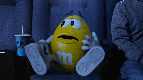 Ad gif. A yellow M&M looks around in fear and leaps out of their seat in the theater saying, "I'm out!" Ad gif. A yellow M&M looks around in fear and leaps out of their seat in the theater saying, "I'm out!"