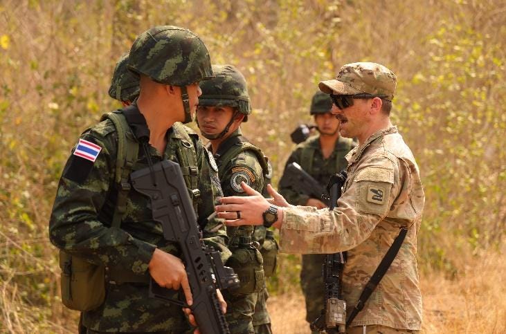 A picture containing grass, person, outdoor, military uniform

Description automatically generated