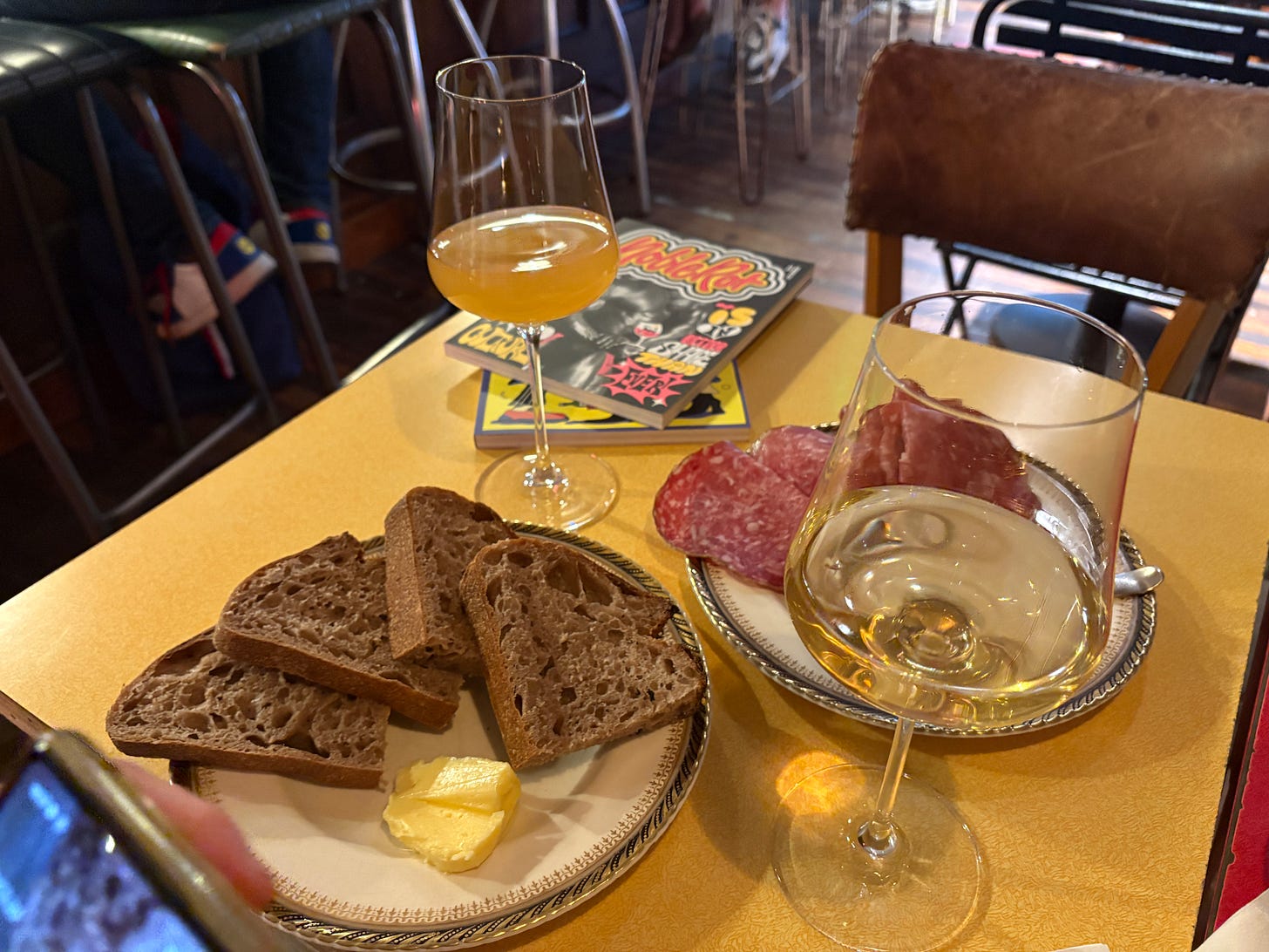 A plate of sourdough and a plate of charcuterie accompany two glasses of wine and two copies of Noble Rot Magazine at 18 Green Street A plate of sourdough and a plate of charcuterie accompany two glasses of wine and two copies of Noble Rot Magazine at 18 Green Street