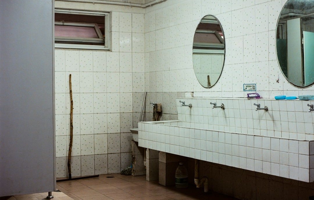 empty public restroom with lights turned on