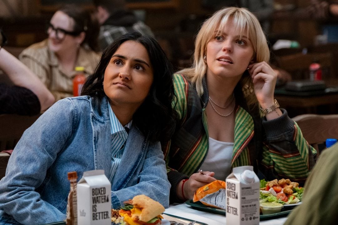 still of Bela and Leighton eating food in the cafeteria from Sex Lives of College Girls