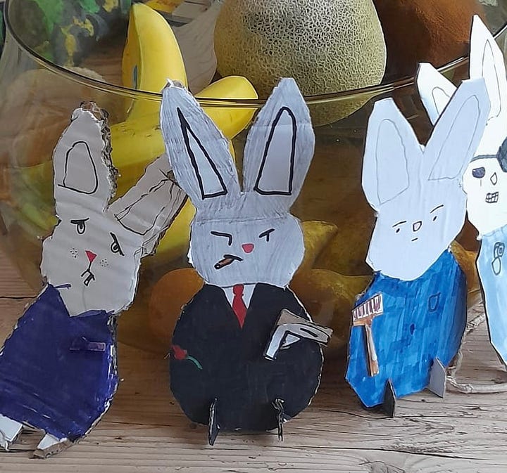 Yellow bag full of crisps, evil Easter bunny drawing by a child, tiny daffodils peeping through, upside down chick