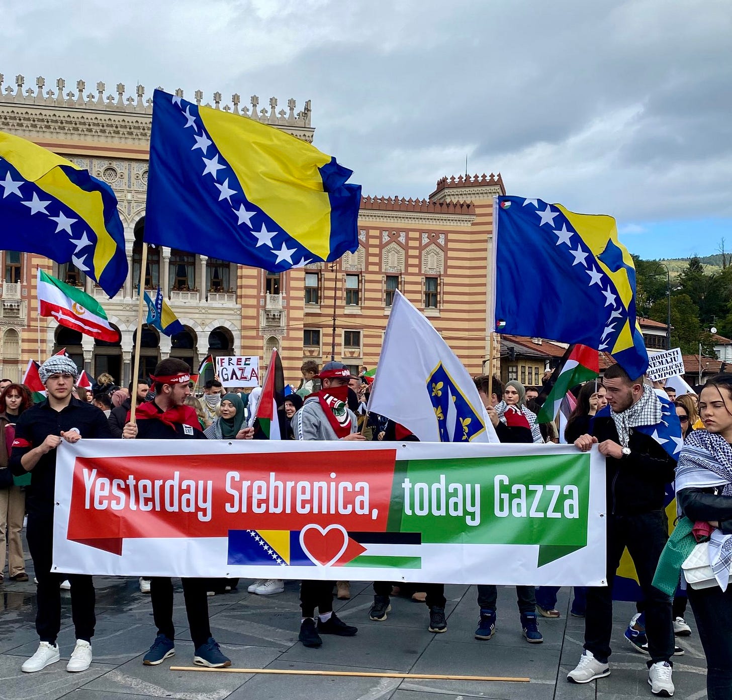 Protesters in Sarajevo carry Bosnian flags and a banner reading "Yesterday Srebenica, today Gaza'