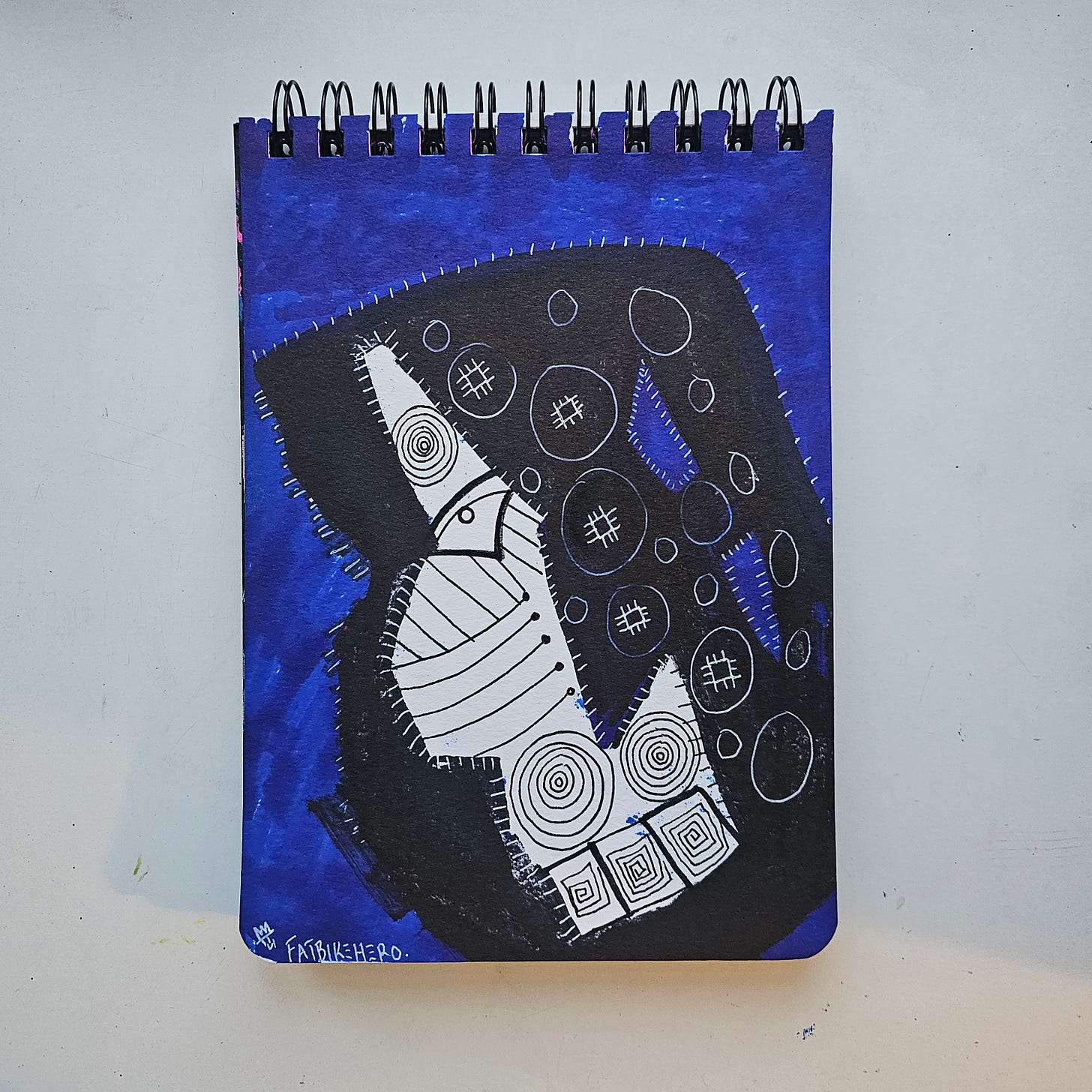 Alt Text: Abstract mixed media drawing by FatbikeHero (b. 1983) featuring a black totem-like shape with white spirals and cross-hatching against a deep blue background.