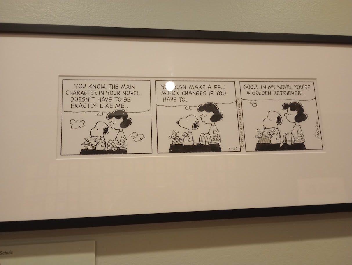 Snoopy, typing, listens to Lucy
