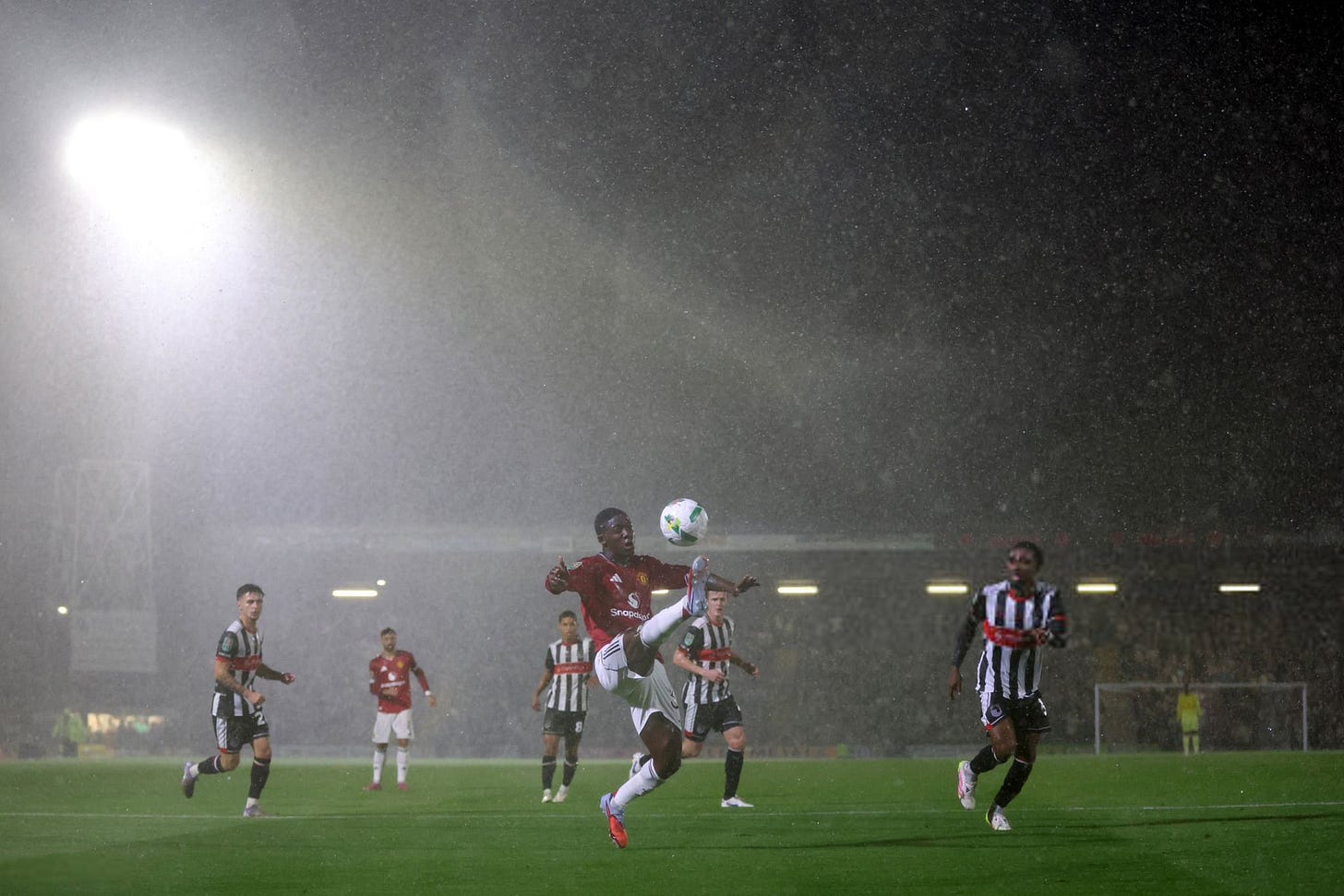 May be an image of 5 people, people playing American football, people playing football, sprinkler, stadium and text