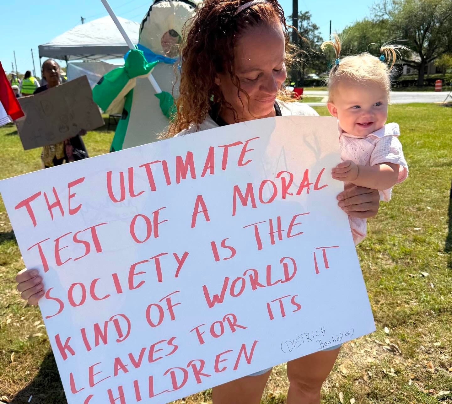 May be an image of baby, standing, banner and text that says 'ULTIMATE MORAL THE A TEST SOCIETY IS THE OF k LEAVES CHTLDREN CHILDREN FOR WORLD ITS IND OF'