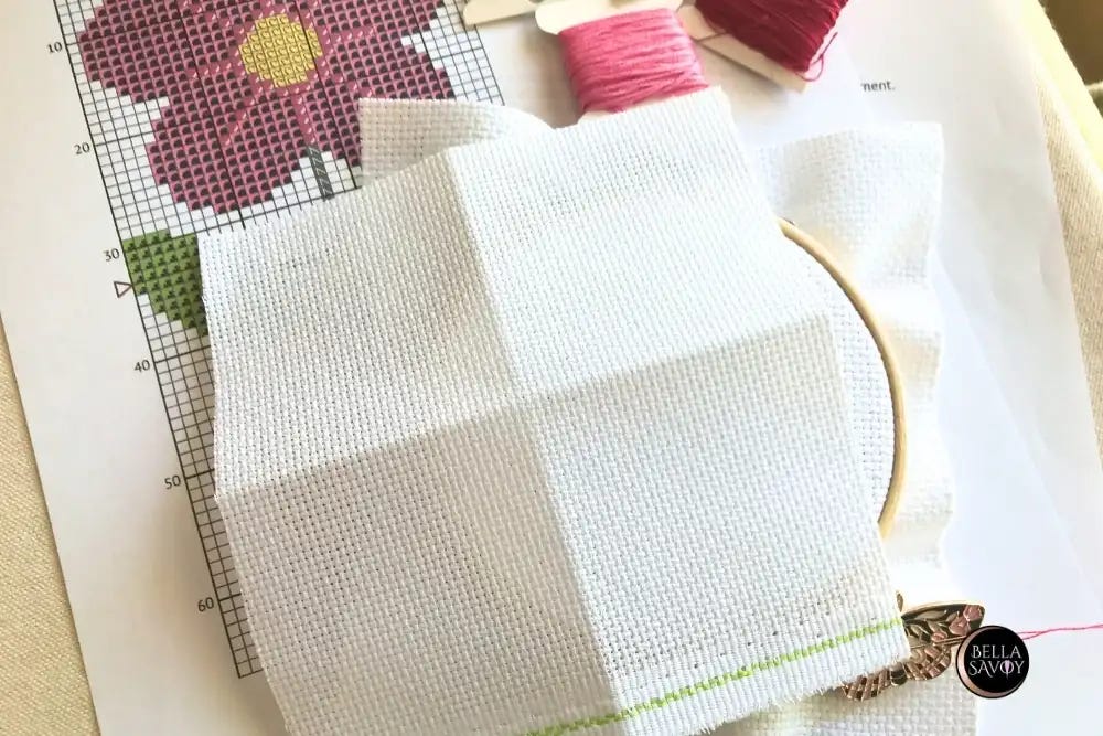 A piece of Aida fabric folded in half vertically and horizontally to find the center
