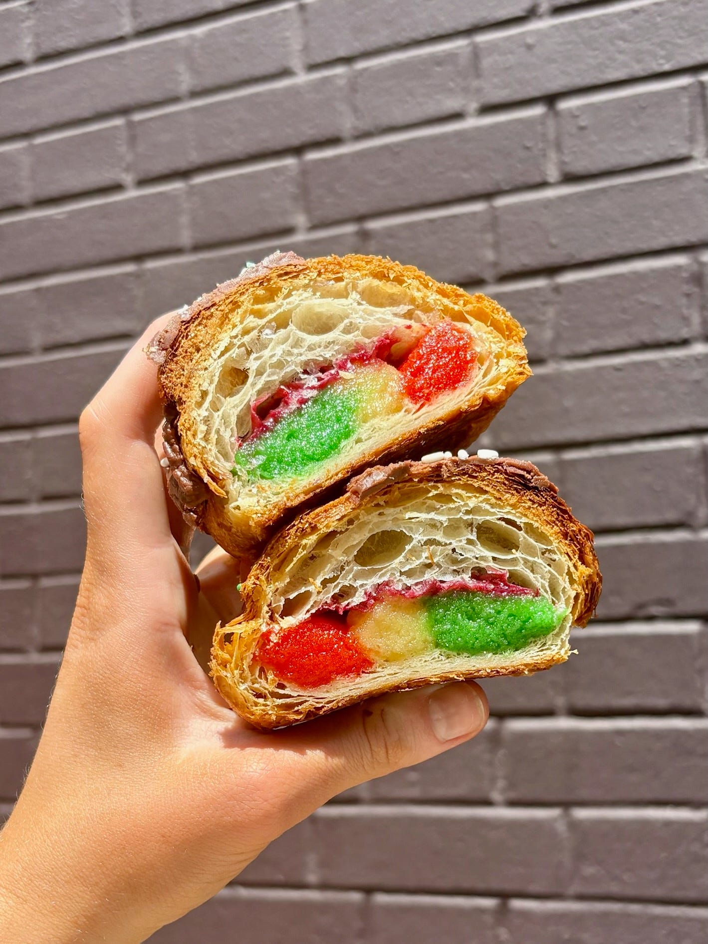 Inside a rainbow cookie croissant. Inside a rainbow cookie croissant.