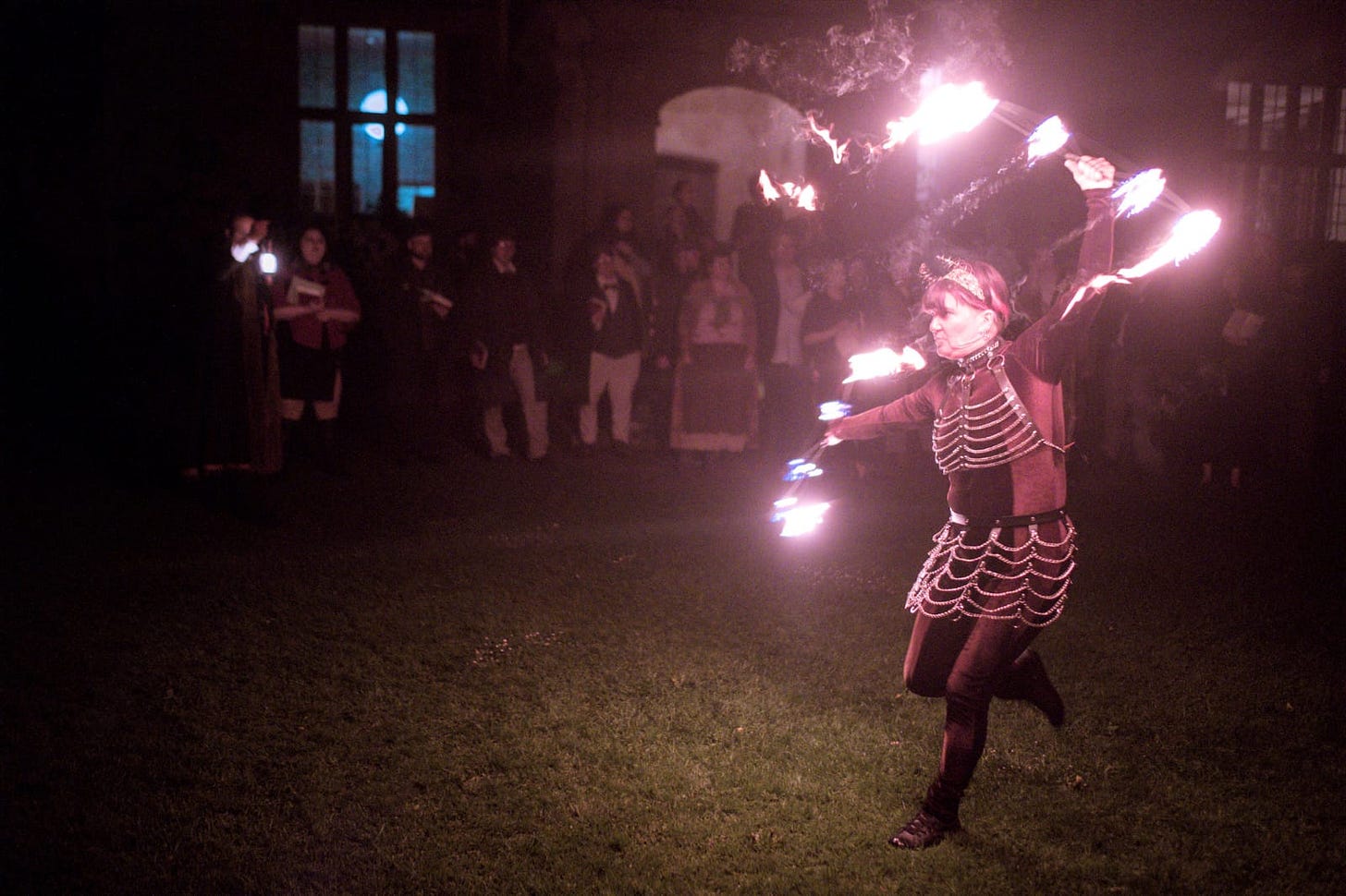 A picture of Scarlet Vikki during a fire performance at night