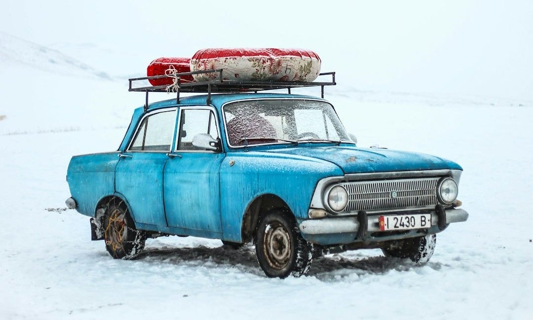 blue sedan on snow ground blue sedan on snow ground