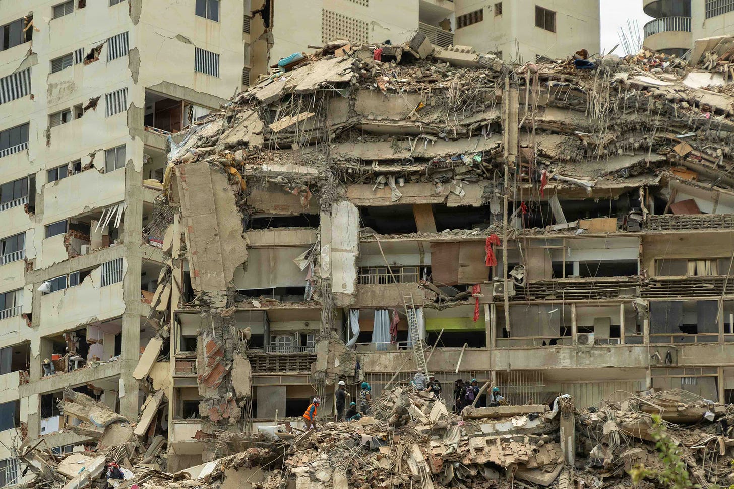 Venezuelan citizens search destroyed buildings in La Guaira, Venezuela on 28 June.
