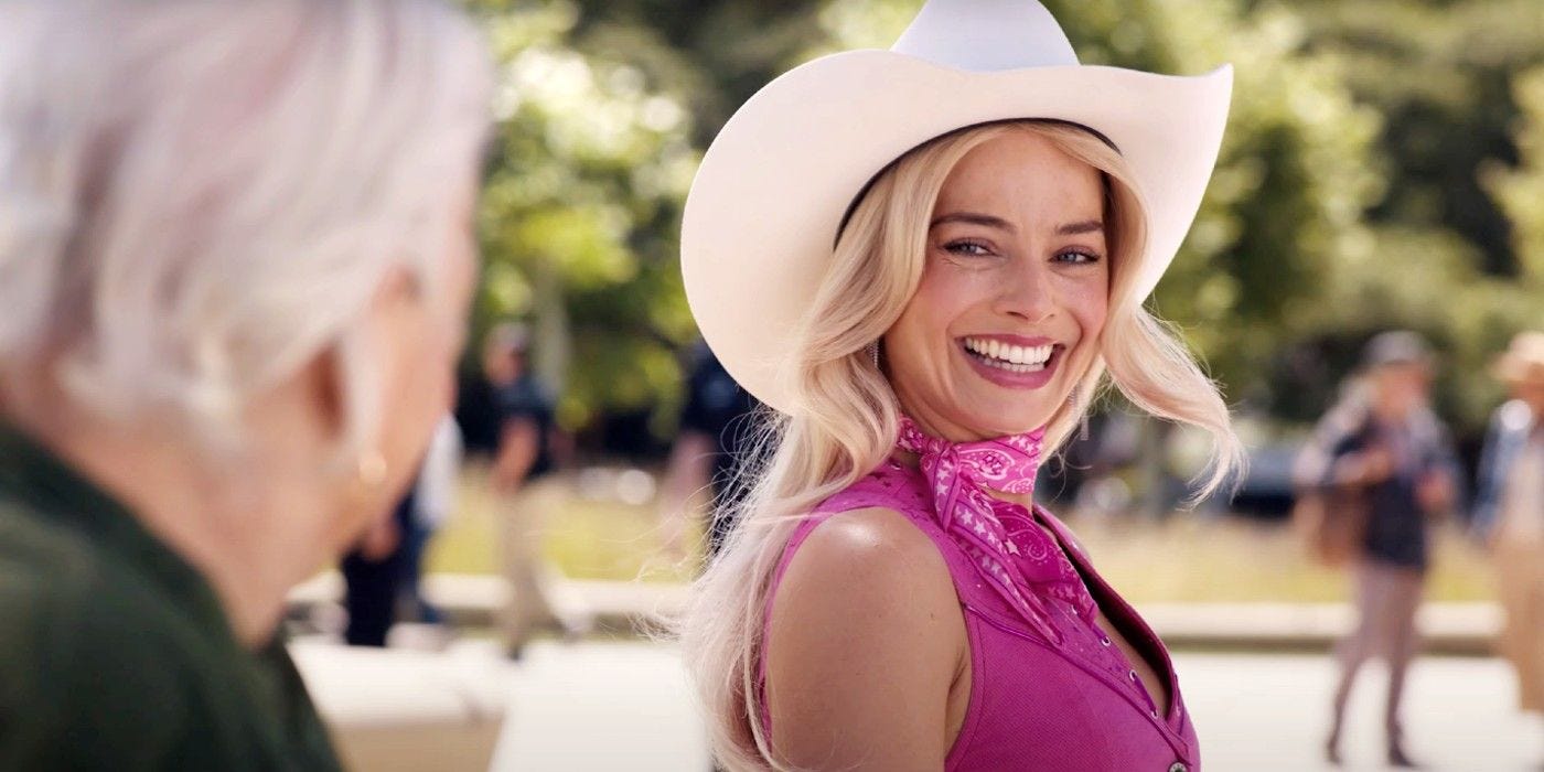 Margot Robbie as Barbie speaking to an old woman