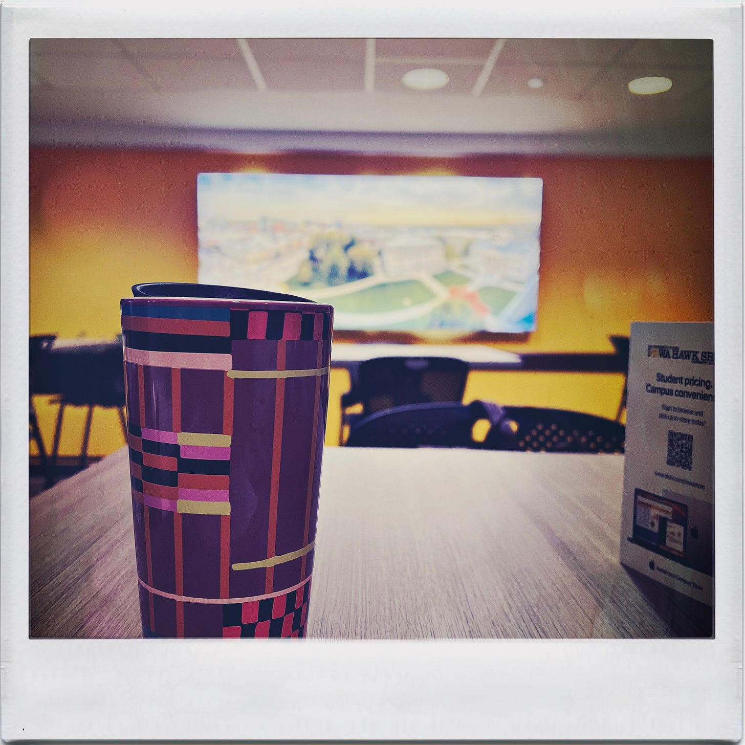 travel coffee mug on a cafe table. 