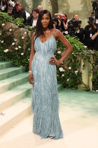 Image may contain Naomi Campbell Clothing Dress Adult Person Fashion Accessories Glasses Camera and Electronics