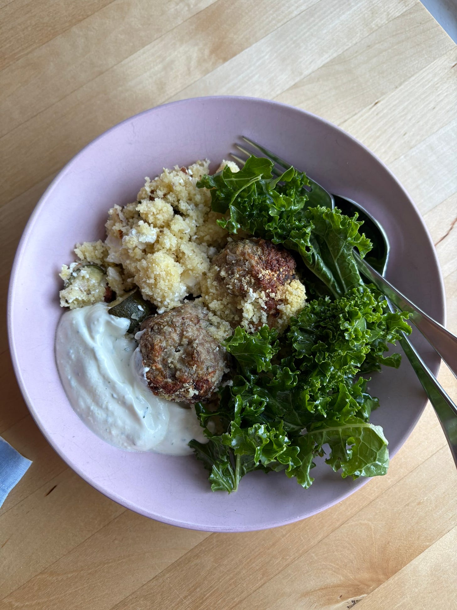 Bowl of cous cous with feta, turkey meatballs, kale and dill yoghurt Bowl of cous cous with feta, turkey meatballs, kale and dill yoghurt