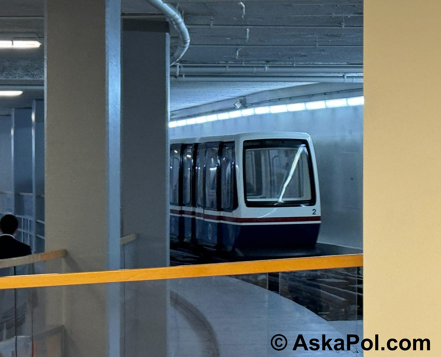 A tram rolls on tracks inside a building as a man walks the opposite direction in the tunnel. Photo © www.askapol.com A tram rolls on tracks inside a building as a man walks the opposite direction in the tunnel. Photo © www.askapol.com
