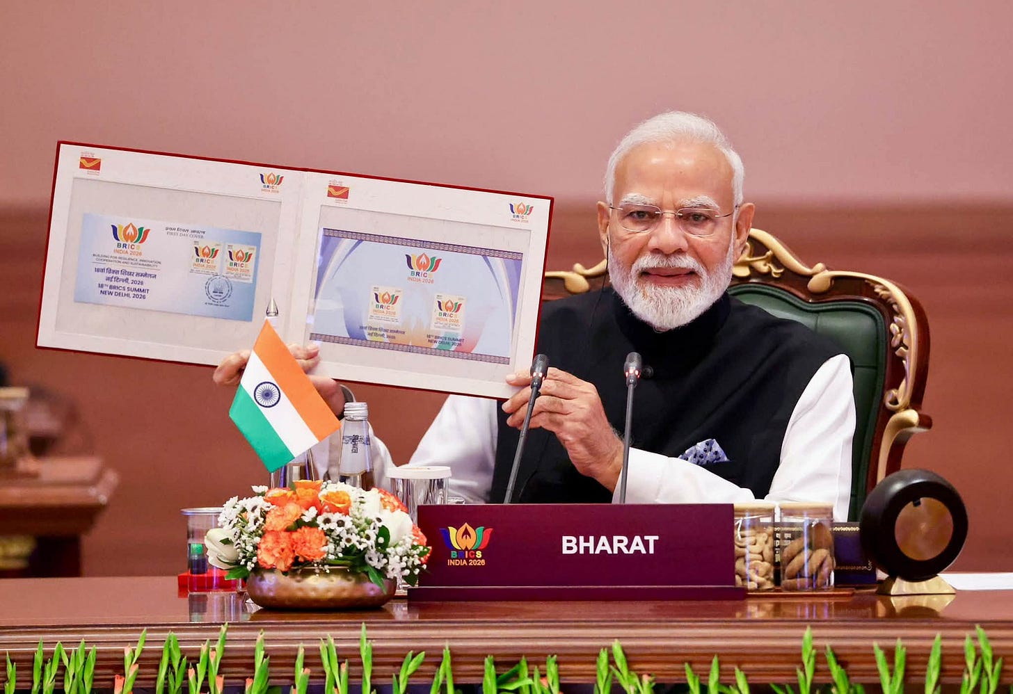 Indian Prime Minister and BRICS Chair Narendra Modi showed the emblem of the 18th BRICS Summit to attendees