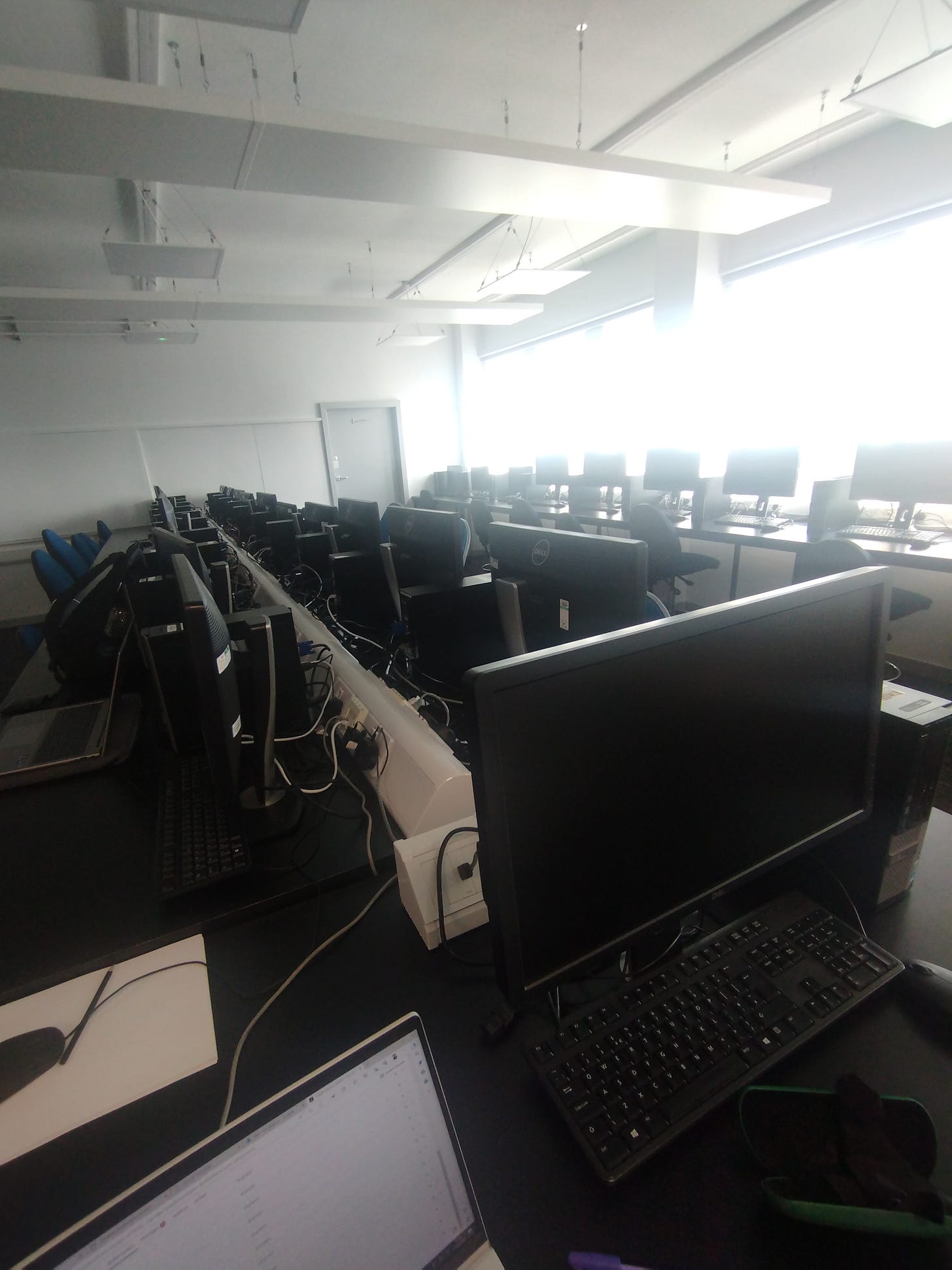 A college lab I spent a lot of time teaching in - numerous computer monitors along long high desks