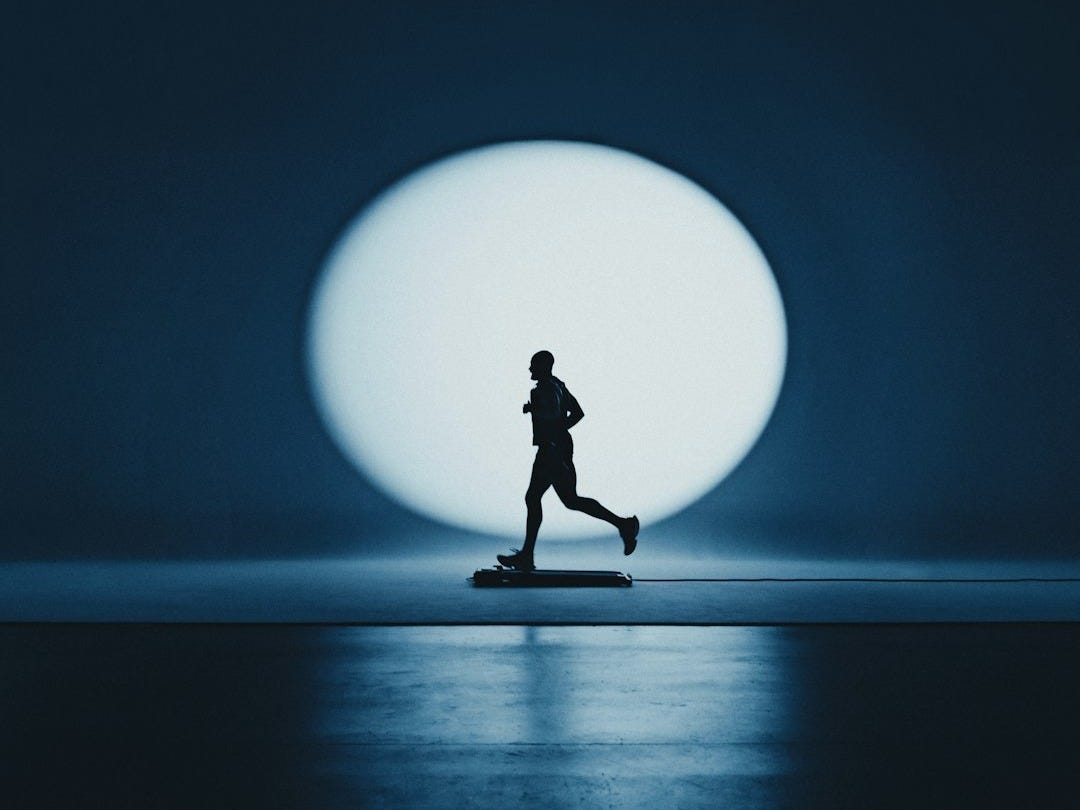 A silhouette of a runner against a large circle.