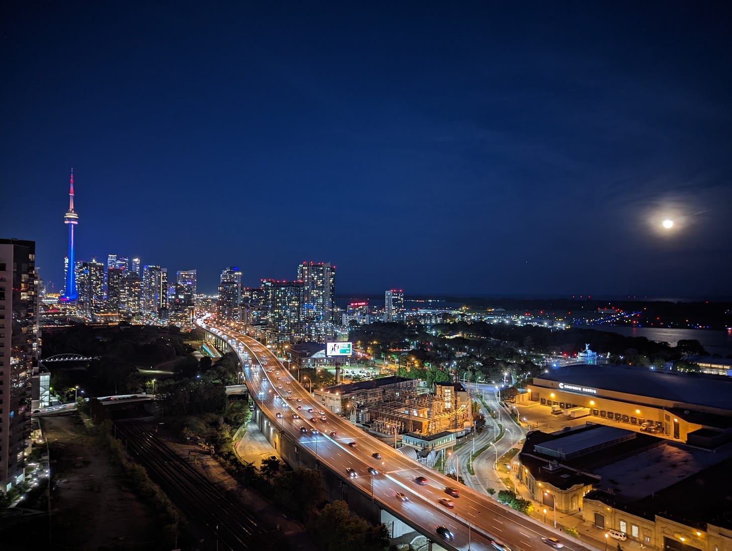 Toronto's skyline under the moonlight, with the Gardiner Expressway at its heart - a testament to the city's car-centric past and a canvas for its sustainable future. Toronto's skyline under the moonlight, with the Gardiner Expressway at its heart - a testament to the city's car-centric past and a canvas for its sustainable future.