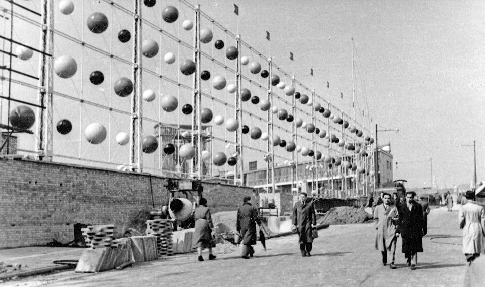 "Row after row of rosy rolling balls spread on tall screens"