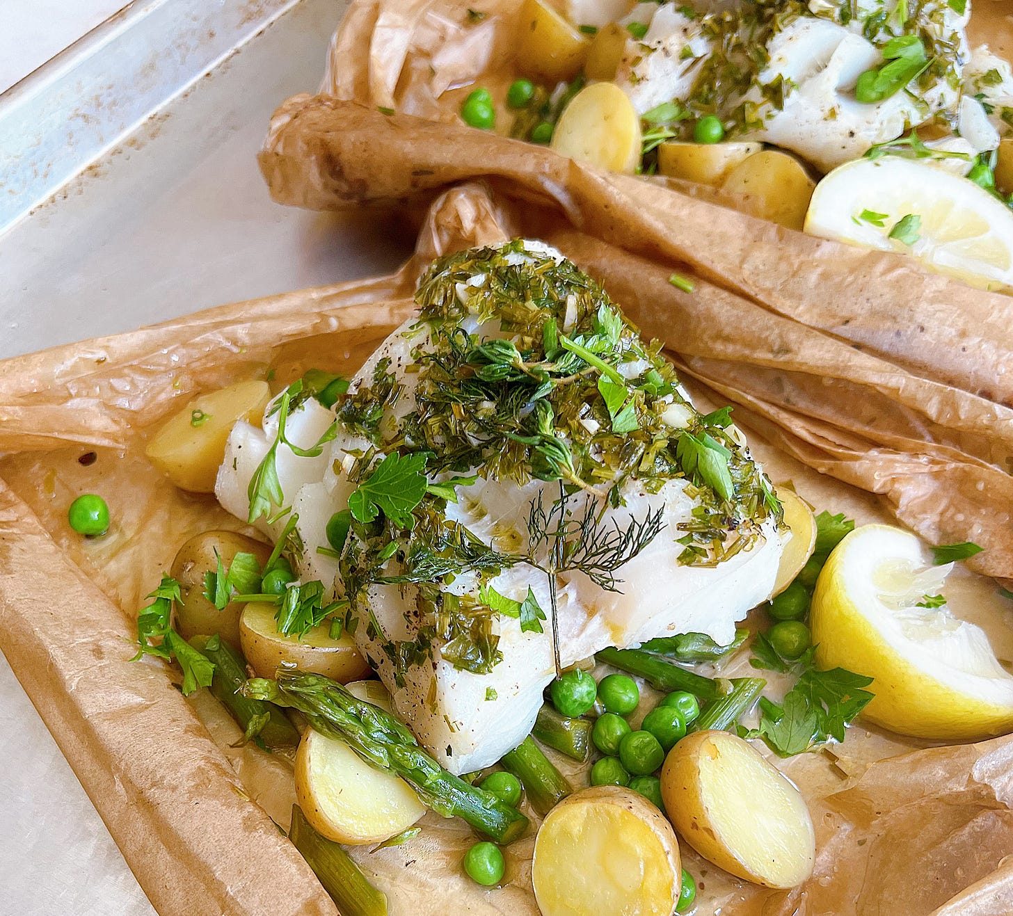 Finished dish with herbs and vegetables and steamed cod